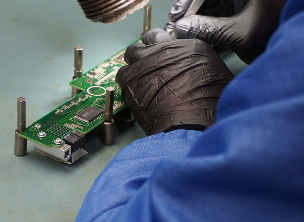 Micross employee working on a PCB board