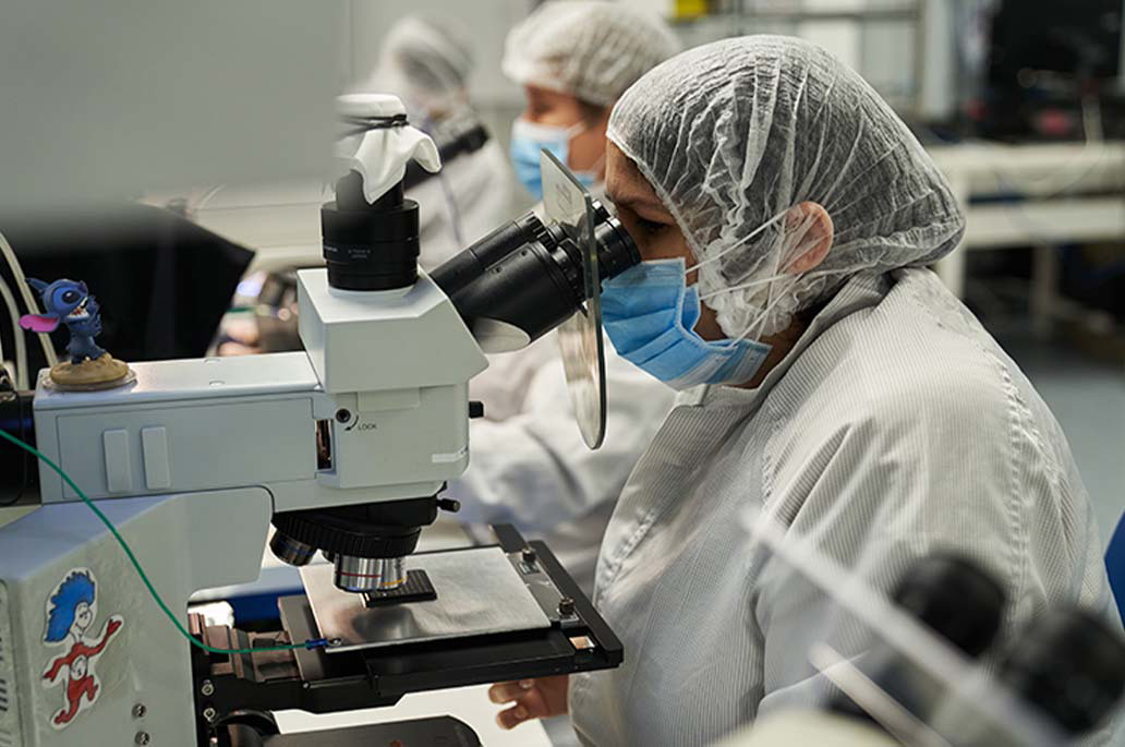 Micross employee inspecting die